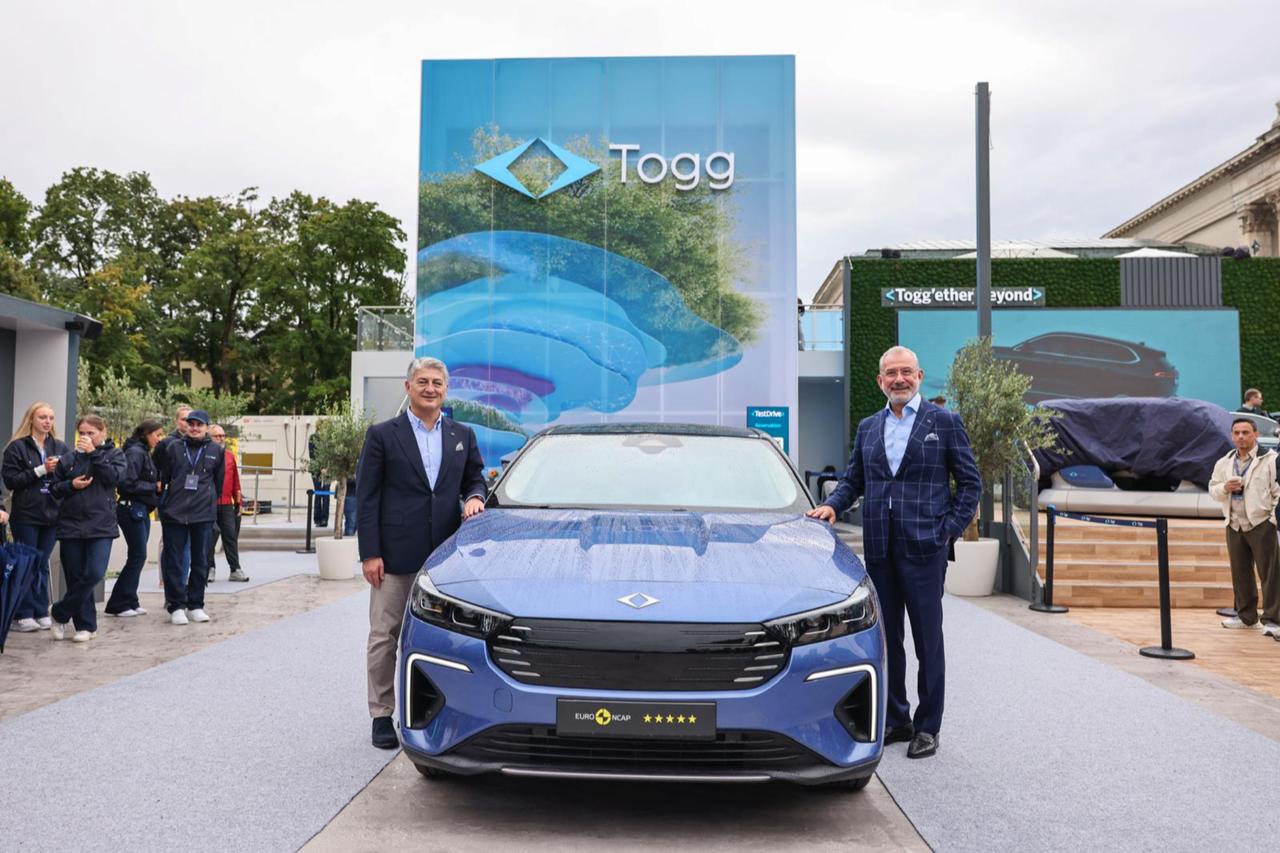 Togg Chairman Fuat Tosyali (R) and Togg CEO Gurcan Karakas (L), Togg T10F Sedan (C) at IAA Mobility 2025 in Munich, Sept. 9, 2025. (Photo via Togg)